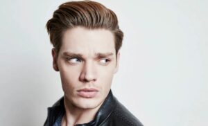 Dominic Sherwood, a track star partner, has strange eyes.  Are his blue and brown eyes a birth defect?